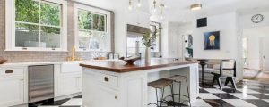 White Island kitchen with 2 stools, chandelier and 4 pane window
