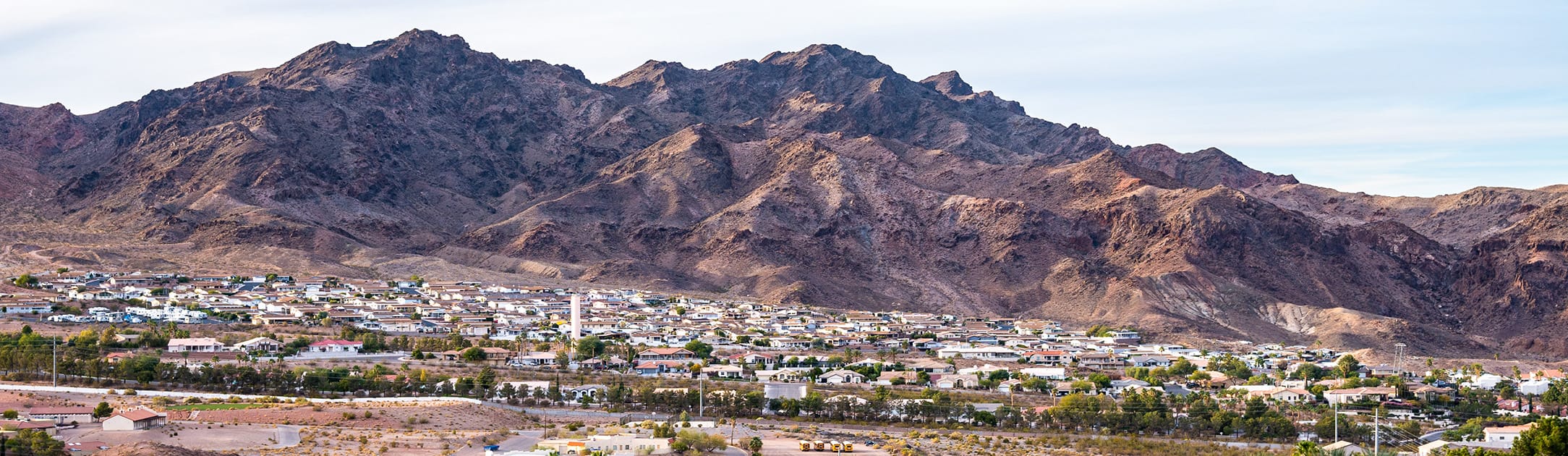 Neighborhood at the base of a tall hill.