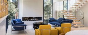 Living room with floating stairs, fireplace and yellow and blur furniture