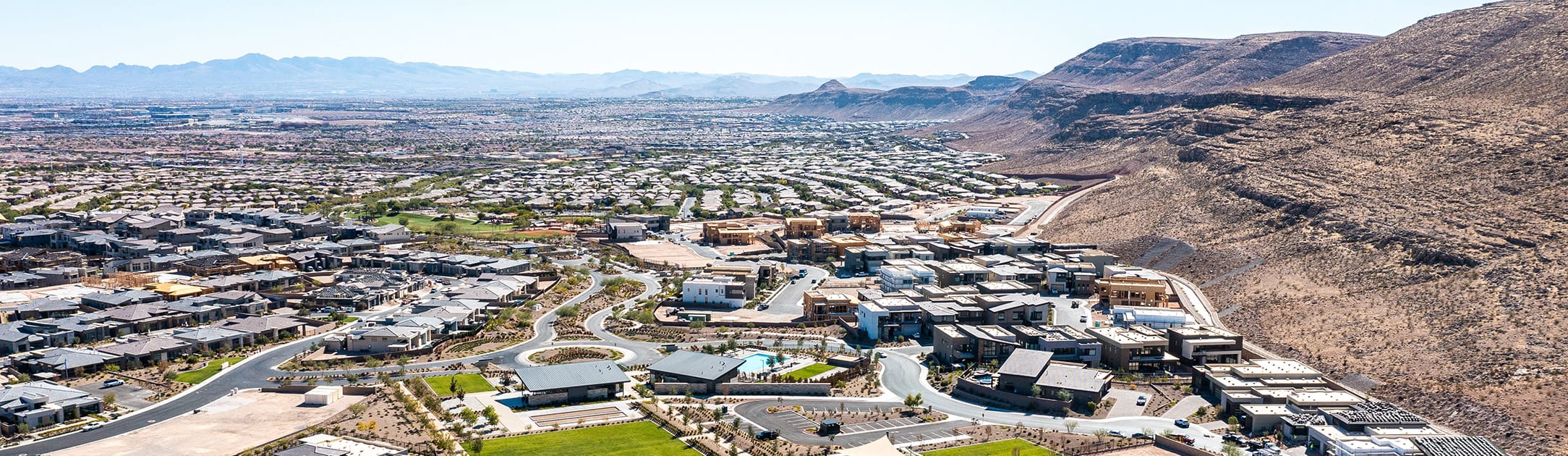 Aerial neighborhood view with hills and mountains