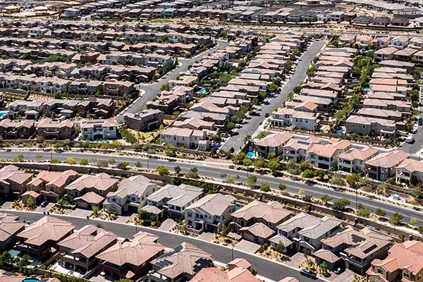 Areal shot of rows of homes and and curve street in the front.