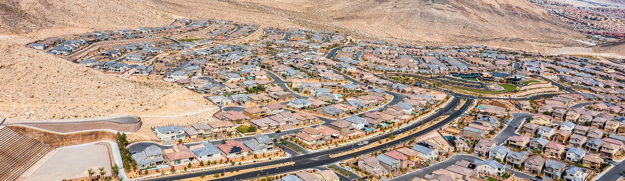 Aerial view of neighborhood with desert and mountains surrounding it.