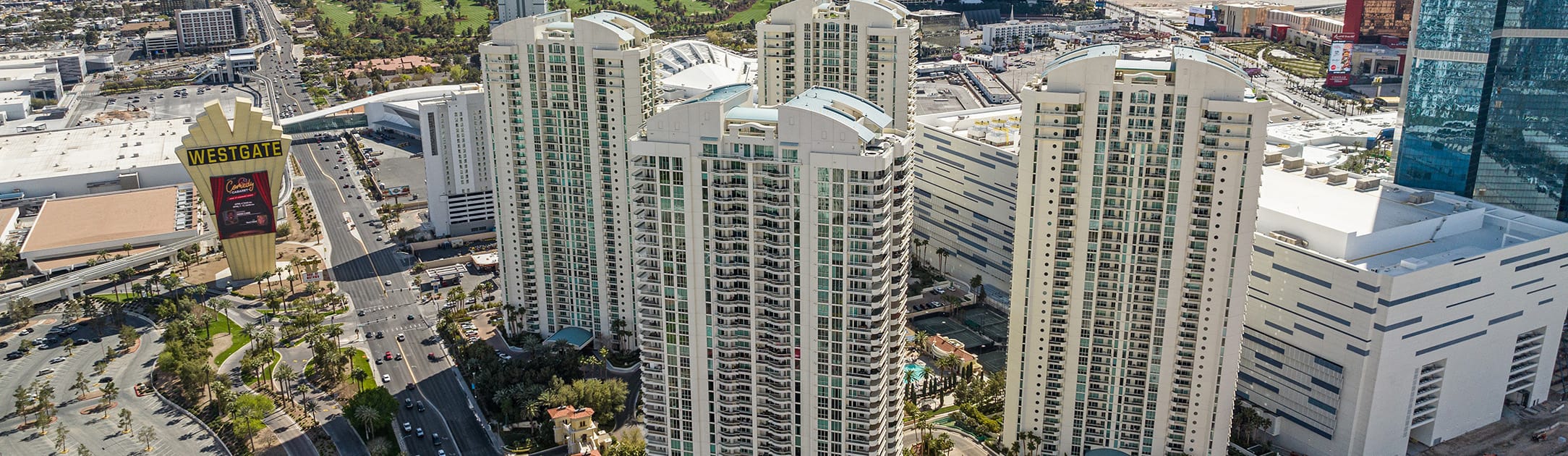 4 high rise towers with businesses in the background and a mall sign to the left that says Westgate.